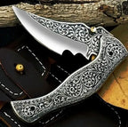 8-inch handmade carbon steel folding knife with engraved metal handle and leather sheath – view 1