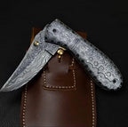 7-inch handmade raindrop Damascus folding knife with matching steel handle and sheath – view 1
