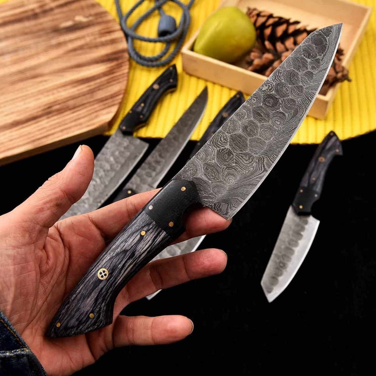 Decorative mosaic pins on charcoal chef knife handles