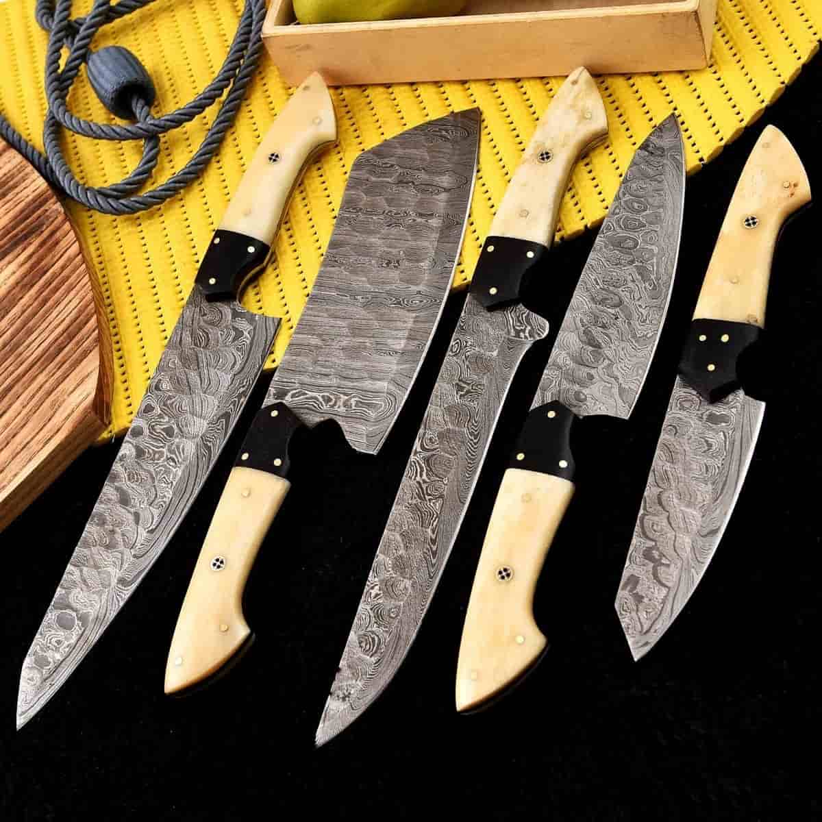 Five culinary blade profiles with cream handles