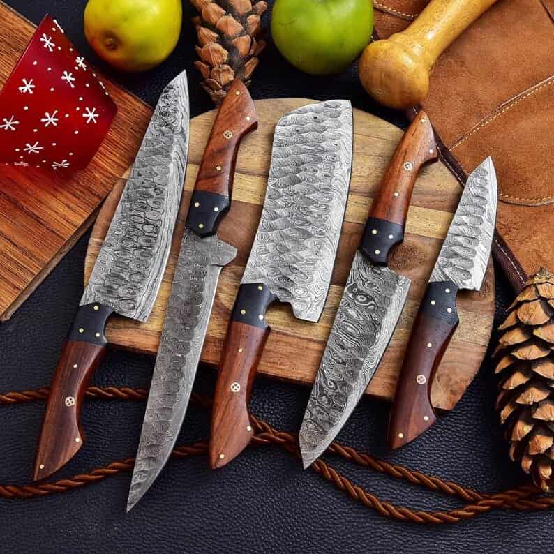Dark wood handles and flowing Damascus blade patterns