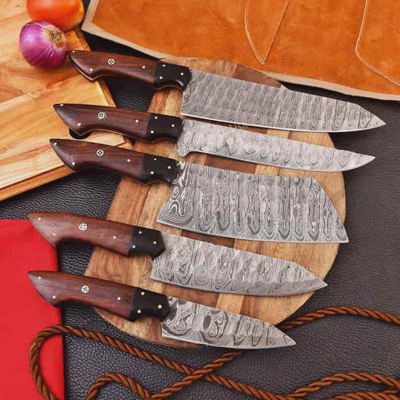 Decorative pin details on dark wood chef knife handles