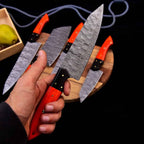 Orange-red wood handles and Damascus blade patterns