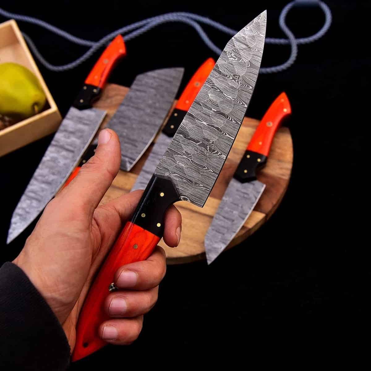 Orange-red wood handles and Damascus blade patterns