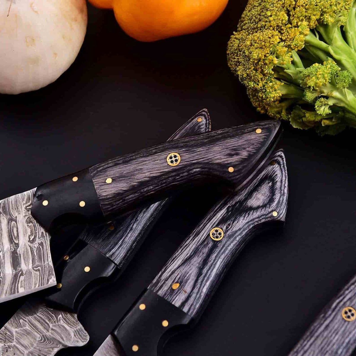 Smoky gray wood handles and Damascus blade patterns