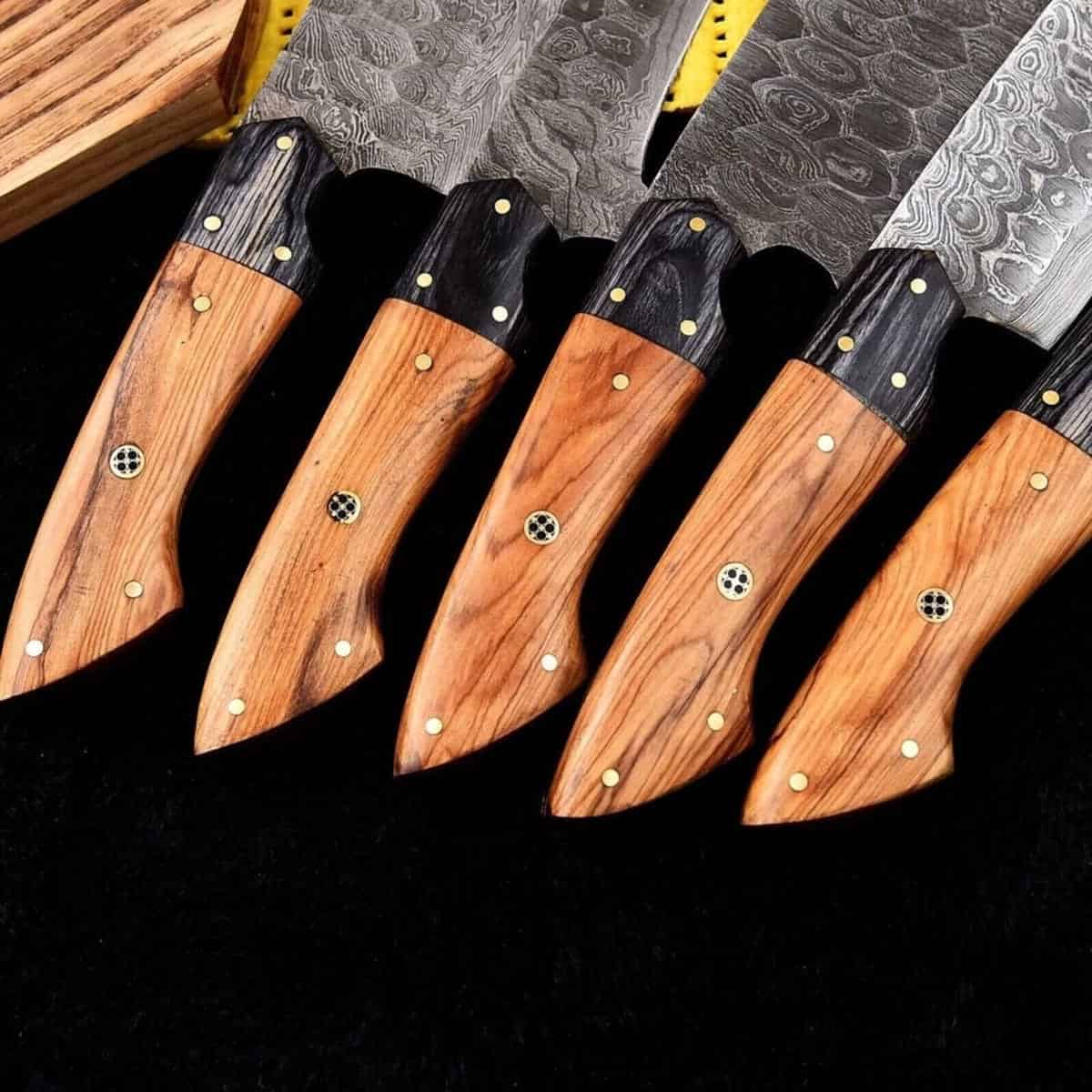 Walnut-tone wood handles and flowing Damascus patterns